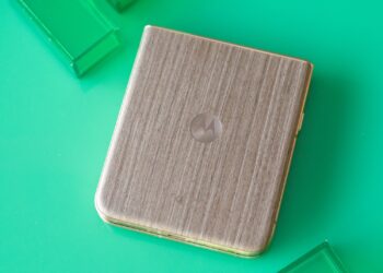 Motorola Razr Ultra on a green background showing wooden back panel