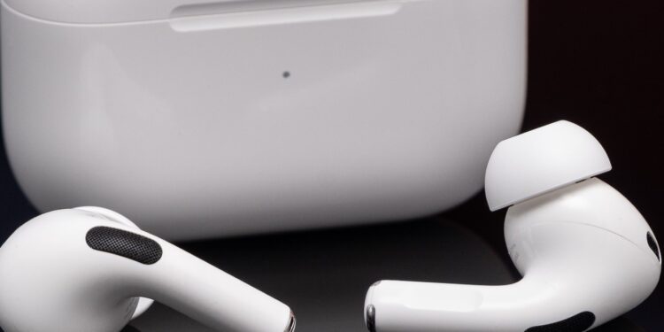 Apple’s second-generation AirPods Pro photographed on a reflective black surface.