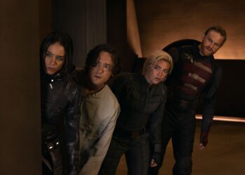 A group of people in superhero costumes peeking out from around a corner.