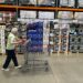 A shopper with a cart in a Costco warehouse.