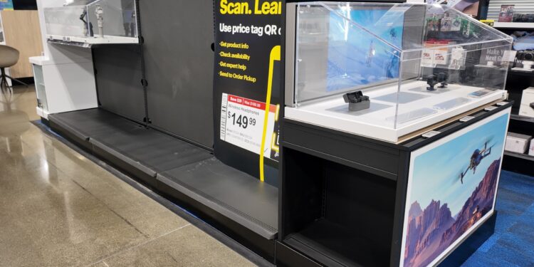 Empty shelves, missing price tags and lockers in the DJI section of Best Buy.