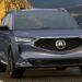 Acura MDX driving on a road.