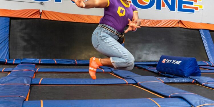 Woman jumping on a trampoline at Sky Zone.