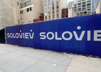 Construction site fence with Soloviev logo.