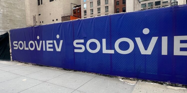 Construction site fence with Soloviev logo.