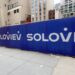 Construction site fence with Soloviev logo.