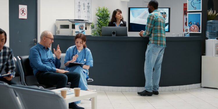 Diverse patients waiting in a hospital lobby.