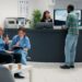 Diverse patients waiting in a hospital lobby.