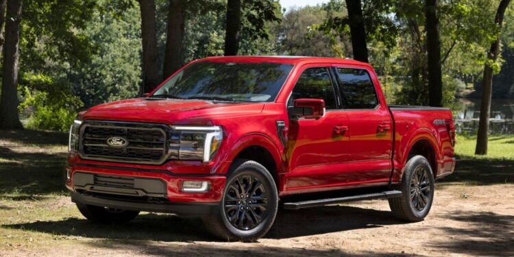 Red Ford F-150 pickup truck parked outdoors.