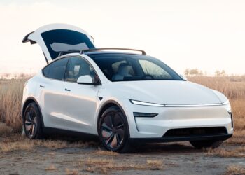 A new Tesla Model Y in white with the trunk raised.