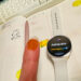 Close up of senior reviewer Victoria Song’s thumb which has been colored yellow orange with a marker.
