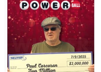 Massachusetts man holding a $2 million Powerball lottery check.