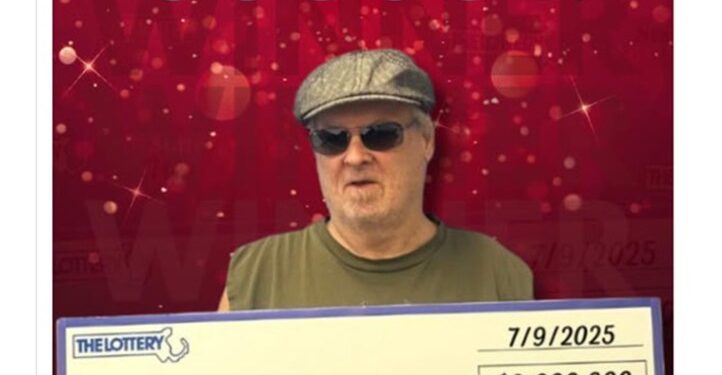 Massachusetts man holding a $2 million Powerball lottery check.