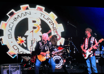 Randy Bachman jams out on guitar with his band.