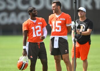 Cleveland Browns quarterback Shedeur Sanders (12) talks to quarterback Joe Flacco (15) during a practice at the team's NFL football training camp Saturday, July 26, 2025, in Berea, Ohio.