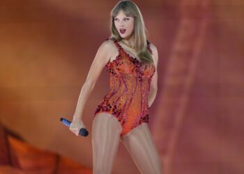 Taylor Swift performing on stage in an orange sequined bodysuit.