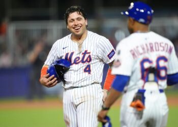 New York Mets catcher Francisco Alvarez (#4) smiles after hitting a single.