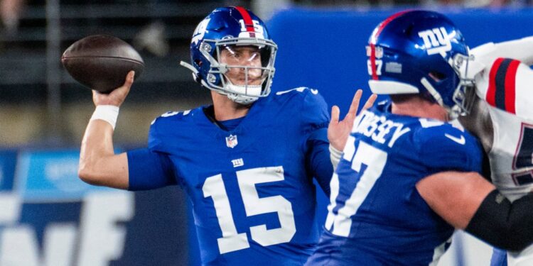 New York Giants quarterback Tommy DeVito throwing a football.