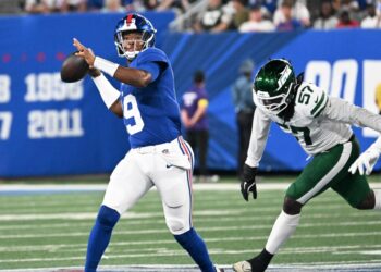 Giants quarterback throwing a football.