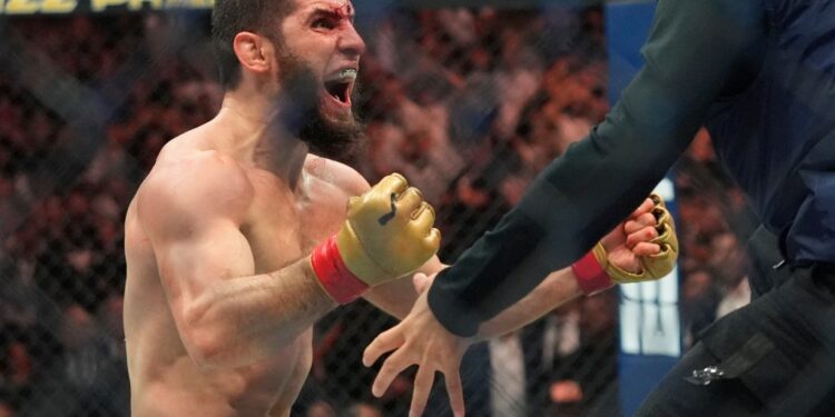 Islam Makhachev celebrates after his win over Dustin Poirier at UFC 302.