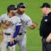 José Caballero (left) is held back by third base coach Luis Rojas as he attempts to get to umpire Bill Miller after being called out attempting to steal second base in the 10th inning of the Yankees' 6-4 win over the Rays. But he still was ejected.