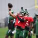 Jets quarterback Justin Fields throwing a football at practice.