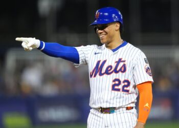 Juan Soto #22 of the New York Mets points during a baseball game.Mets outfielder Juan Soto (22) reacts after being walked against the Seattle Mariners in the third inning at Journey Bank Ballpark
