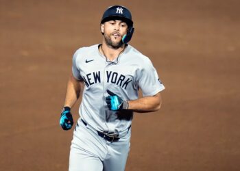 New York Yankees baseball player running on the field.