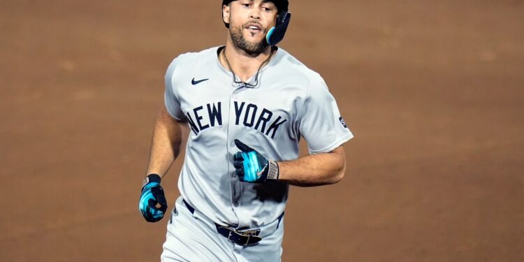 New York Yankees baseball player running on the field.