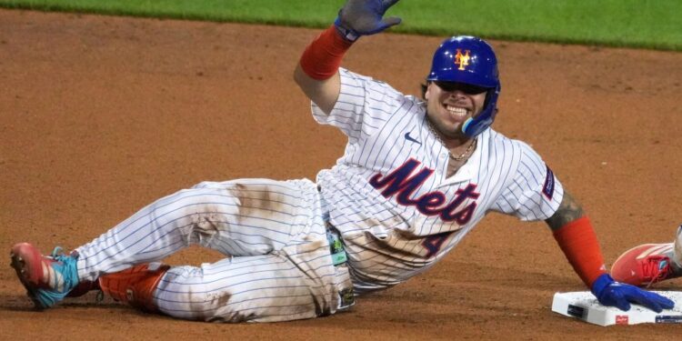 New York Mets player Francisco Alvarez sliding into second base.
