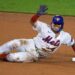 New York Mets player Francisco Alvarez sliding into second base.