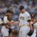 San Diego Padres starting pitcher Michael King, center, hands the ball to manager Mike Shildt (8) as he exits during the third inning of a baseball game against the Boston Red Sox Saturday, Aug. 9, 2025, in San Diego.