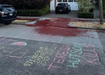 The chalk and red paint outside a Microsoft executive’s home (blurred and cropped to remove details).