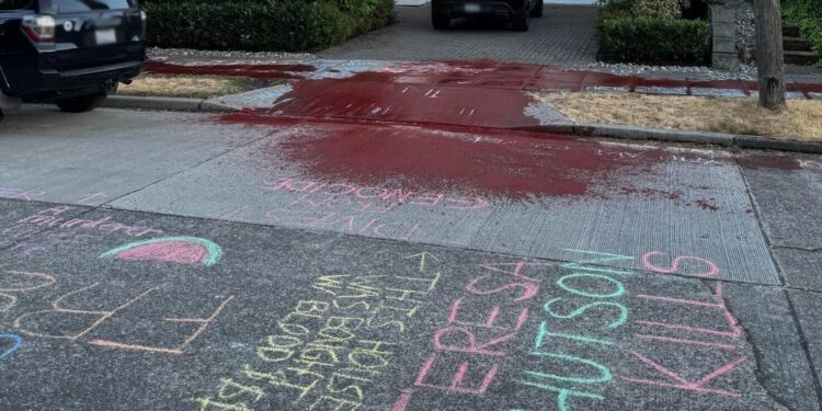 The chalk and red paint outside a Microsoft executive’s home (blurred and cropped to remove details).