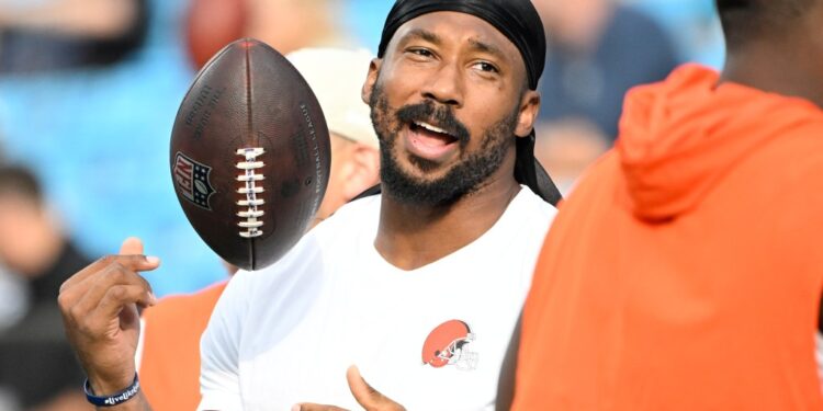 Myles Garrett, Cleveland Browns defensive end, holding a football.