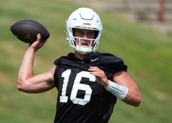 Texas football player throwing a football.