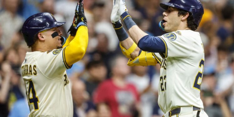 Milwaukee Brewers' Christian Yelich, right, high-fives with William Contreras after Yelich hit a two-run home run against the Pittsburgh Pirates during the fifth inning of a baseball game, Tuesday, Aug.12, 2025, in Milwaukee.