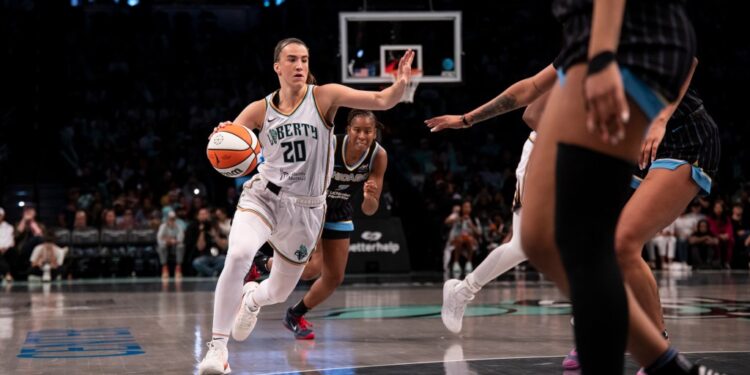 Sabrina Ionescu #20 of the New York Liberty dribbling the ball.