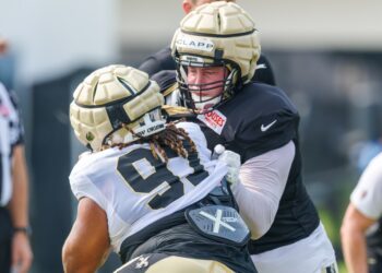 New Orleans Saints center Will Clapp (76) blocks defensive tackle Khristian Boyd (97) during training camp at Ochsner Sports Performance Center.