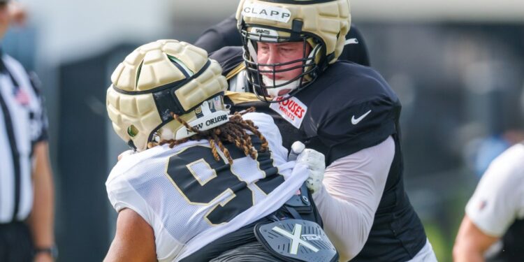 New Orleans Saints center Will Clapp (76) blocks defensive tackle Khristian Boyd (97) during training camp at Ochsner Sports Performance Center.