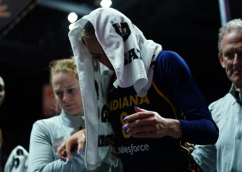 Indiana Fever player Sophie Cunningham (8) is helped off the court with an injury.