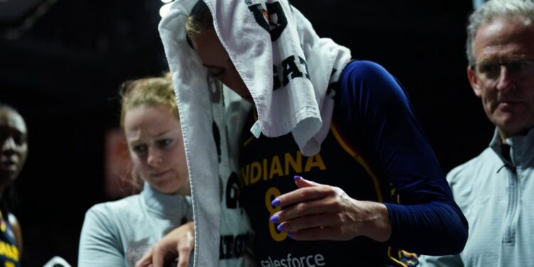 Indiana Fever player Sophie Cunningham (8) is helped off the court with an injury.