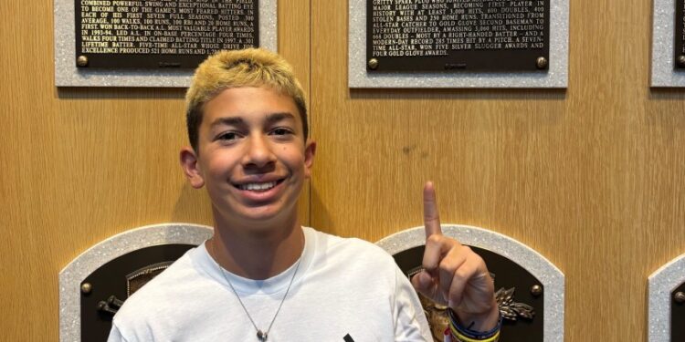 St. John's-Smithtown Little League star Jeremy Katz points to his hero Craig Biggio's plaque at the Baseball Hall of Fame.