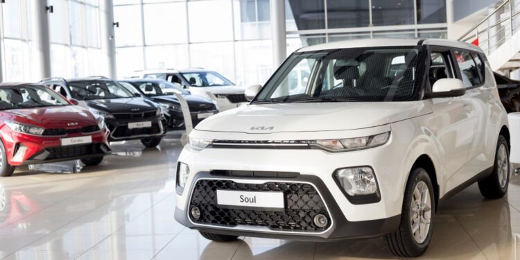 White Kia Soul in a car showroom.