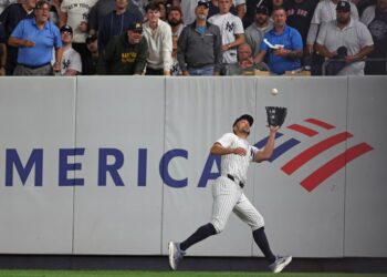 Giancarlo Stanton making a catch in a baseball game.