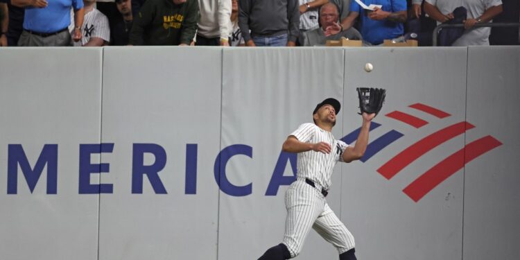 Giancarlo Stanton making a catch in a baseball game.