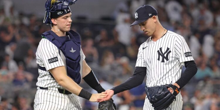 New York Yankees catcher and pitcher shaking hands.