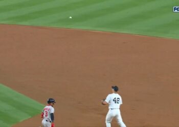 Yankees player #48 fielding a ground ball.