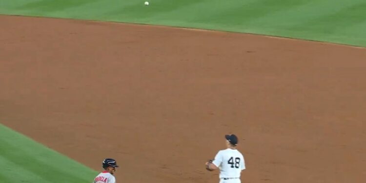 Yankees player #48 fielding a ground ball.