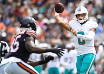 Zach Wilson, Miami Dolphins quarterback, throwing a football.